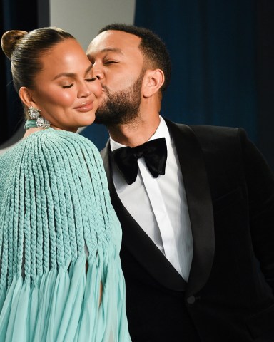 Chrissy Teigen, left, and husband John Legend arrive at the Vanity Fair Oscar Party on Sunday, Feb. 9, 2020, in Beverly Hills, Calif. (Photo by Evan Agostini/Invision/AP)