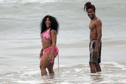 EXCLUSIVE: Singer SZA was smiling on the beach in Hawaii as she celebrated her chart-topping success with her new album 'SOS'.  The 33-year-old hitmaker - whose real name is Solana Imani Rowe - looked happy and relaxed as she headed to the beach with producer ThankGod4Cody, who is credited with seven songs on the history-making R&B album.  She wore a pink camisole and matching sarong, and revealed a mini skirt as she cooled off with a dip in the ocean.  The New Jersey-grown R&B singer-songwriter is currently number one on the Billboard 200 with her long-awaited second LP.  She recently took to Instagram, telling fans: "3 weeks at number one totally taking care of my business and giving no af**k.  Thanks God." In her latest lyrics, the 'Hit Different' singer seems to address the plastic surgery rumors, responding to the rampant speculation surrounding whether her body has received a cosmetic upgrade or not. Are not.  January 3, 2023 Photo: SZA.  Photo credit: MEGA TheMegaAgency.com +1 888 505 6342 (Mega Agency TagID: MEGA929982_021.jpg) [Photo via Mega Agency]