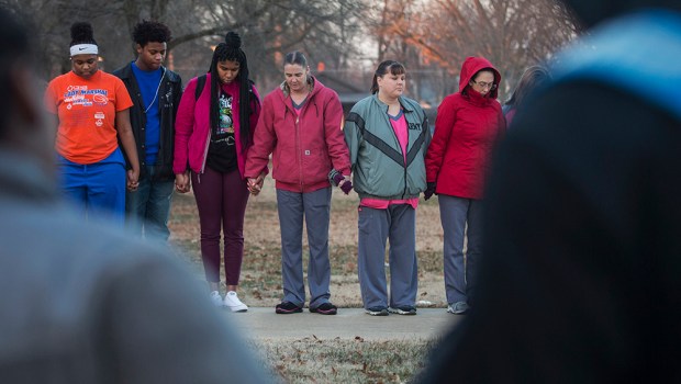 Students and community members hold hands in prayer before classes at Paducah Tilghman High School in Paducah, Ky., Wednesday, Jan. 24, 2018. The gathering was held for the victims of the Marshall County High School shooting on Tuesday. (Ryan Hermens/The Paducah Sun via AP)