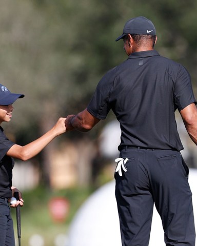 Tiger Woods, right, fist bumps his son Charlie during the first round of the PNC Championship golf tournament, in Orlando, Fla. Woods is back playing after getting injured in a car accident. He is paired with his son Charlie during the tournament
PNC Championship Golf, Orlando, United States - 17 Dec 2021