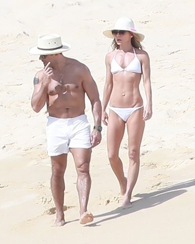 Cabo San Lucas, MEXICO  - *EXCLUSIVE*  - The mother-of-three showed off her rock hard body in a tiny white bikini while strolling along the sand with hubby Mark Consuelos.Pictured: Kelly Ripa and Mark ConsuelosBACKGRID USA 27 JANUARY 2019 BYLINE MUST READ: HEM / BACKGRIDUSA: +1 310 798 9111 / usasales@backgrid.comUK: +44 208 344 2007 / uksales@backgrid.com*UK Clients - Pictures Containing ChildrenPlease Pixelate Face Prior To Publication*