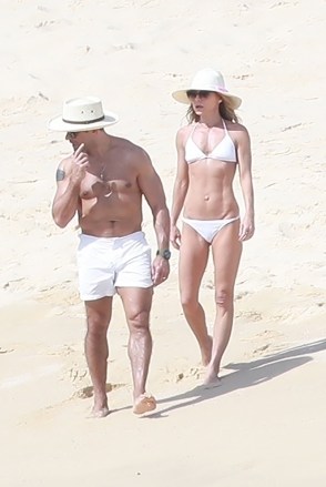 Cabo San Lucas, MEXICO - *EXCLUSIVE* - Mother-in-law in a tiny white bikini shows off her tough body as she walks on the sand with husband Mark Consuelos.  Image: Kelly Ripa and Mark Consuelos Backgrid USA 27 January 2019 BYLINE MUST READ: HEM / BACKGRID USA: +1 310 798 9111 / usasales@backgrid.com UK: +44 208 344 2007 / uksales@backgrid.com *UK Customers - photo Containing children Please pixelate face before publication*
