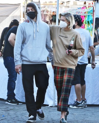 West Hollywood, CA  - *EXCLUSIVE* Jaime King sips on a Coca-Cola while smoking a cigarette as she enjoys her afternoon with her new boyfriend, Sennett Devermont at the Flea Market in West Hollywood.  Pictured: Jaime King, Sennett Devermont  BACKGRID USA 20 DECEMBER 2020   USA: +1 310 798 9111 / usasales@backgrid.com  UK: +44 208 344 2007 / uksales@backgrid.com  *UK Clients - Pictures Containing Children Please Pixelate Face Prior To Publication*
