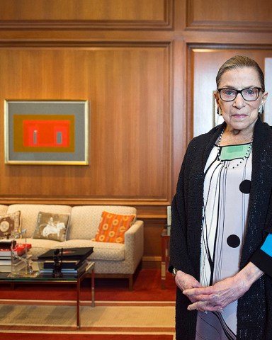 FILE - In this July 31, 2014, file photo, Associate Justice Ruth Bader Ginsburg in her Supreme Court chambers in Washington. In different circumstances, Ginsburg might be on a valedictory tour in her final months on the Supreme Court. But in the era of Donald Trump, the 84-year-old Ginsburg is packing her schedule and sending signals she intends to keep her seat on the bench for years. (AP Photo/Cliff Owen, File)