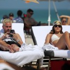 Amelia Hamlin shows off her curves in a white bikini as she hits the beach with boyfriend Scott Disick on Valentine's Day in Miami