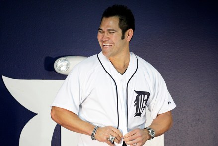 Detroit Tigers' Johnny Damon buttons his new jersey during a news conference at the team' spring training baseball practice facility, Monday, Feb. 22, 2010, in Lakeland, Fla. Damon signed a one-year contract with the Detroit Tigers.  (AP Photo/Eric Gay)