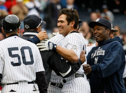New York Yankees coaches and staff celebrate with Johnny Damon, second from right, after his tenth inning, walk-off solo home run in their 3-2 victory over the Minnesota Twins in a baseball game at Yankee Stadium in New York, Sunday, May 17, 2009. (AP Photo/Kathy Willens)