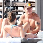 EXCLUSIVE: DJ Diplo looks happy as he is surrounded by bikini-clad women on the beach in Miami