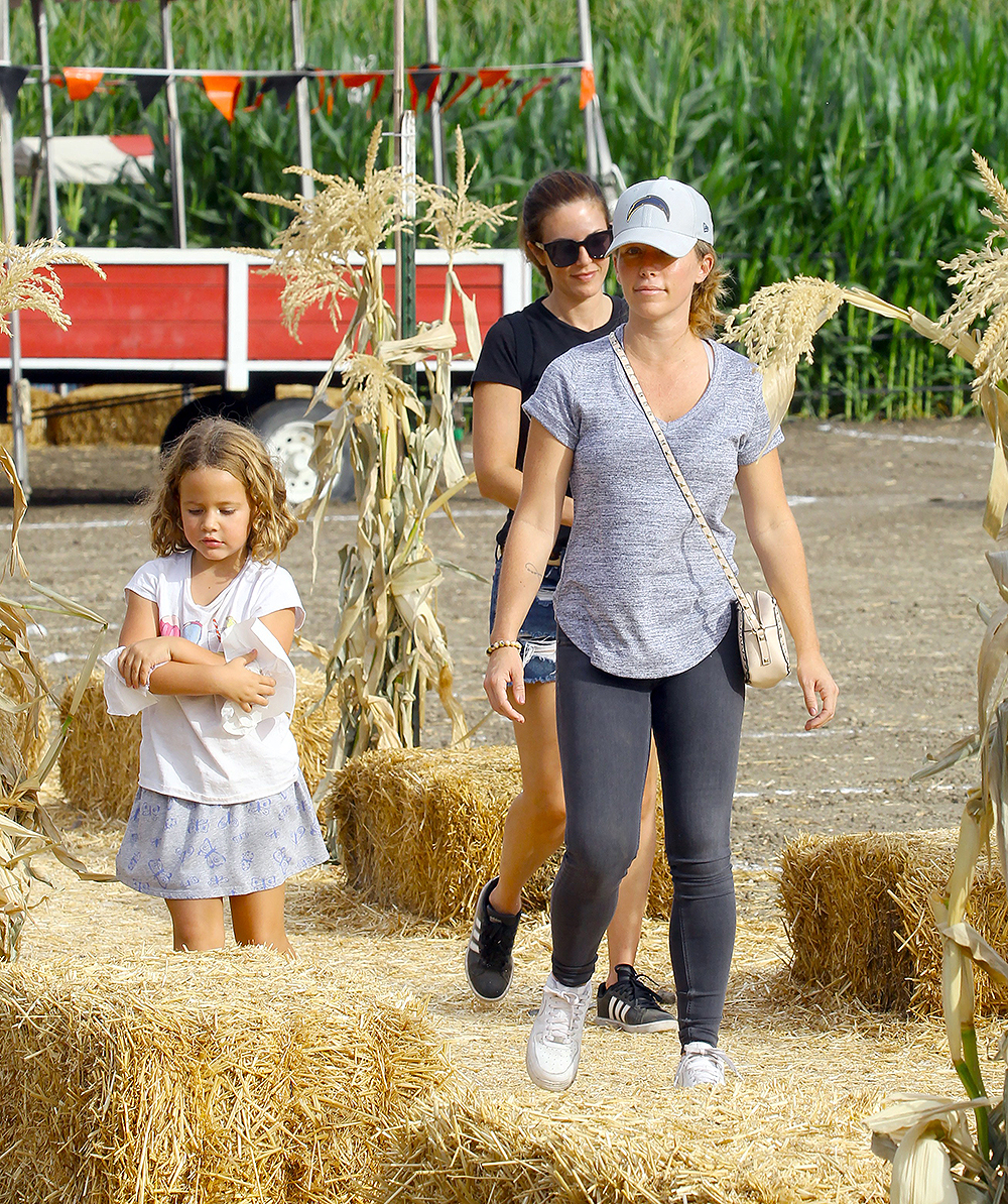 EXCLUSIVE: Kendra Wilkinson carries a  couple of pumpkins as she stops by a pumpkin patch in Woodland Hills