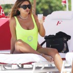 EXCLUSIVE: Larsa Pippen stands out in a neon yellow swimsuit as she hits the beach with friends in Miami