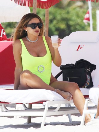 EXCLUSIVE: Larsa Pippen stands out in a neon yellow swimsuit as she hits the beach with friends in Miami. 28 May 2021 Pictured: Larsa Pippen. Photo credit: MEGA TheMegaAgency.com +1 888 505 6342 (Mega Agency TagID: MEGA758458_012.jpg) [Photo via Mega Agency]