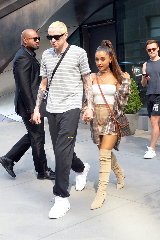 Ariana Grande and her boyfriend holding hands while leaving their apartment today on their way to do some shopping in New York City