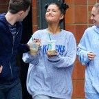 Ariana Grande takes a break from thinking about ex Mac Miller as she walks in the rain with her friends and go to the park to enjoy coffee in New York