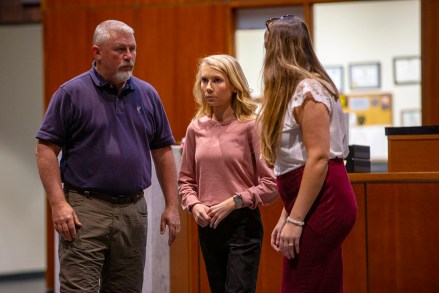 Brooke Skylar Richardson, center, arrives with her father Scott Richardson, left, for jury selection in her trial at the Warren County Courthouse Tuesday, Sept. 3, 2019, in Lebanon, Ohio. Richardson, 20, accused of killing and burying her newborn daughter in her family's backyard in the southwest Ohio village of Carlisle, is charged with aggravated murder, involuntary manslaughter, gross abuse of a corpse, tampering with evidence and child endangerment in the death of her newborn infant. She faces the possibility of life in prison. (Cara Owsley/The Cincinnati Enquirer via AP, Pool)