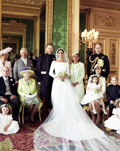 In this photo released by Kensington Palace, shows an official wedding photo of Britain's Prince Harry and Meghan Markle, center, in Windsor Castle, Windsor, England, Saturday May 19, 2018. Others in photo from left, back row, Jasper Dyer, Camilla, Duchess of Cornwall, Prince Charles, Doria Ragland, Prince William; center row, Brian Mulroney, Prince Philip, Queen Elizabeth II, Kate, Duchess of Cambridge, Princess Charlotte, Prince George, Rylan Litt, John Mulroney; front row, Ivy Mulroney, Florence van Cutsem, Zalie Warren, Remi Litt
Britain Royal Wedding, Windsor, United Kingdom - 21 May 2018