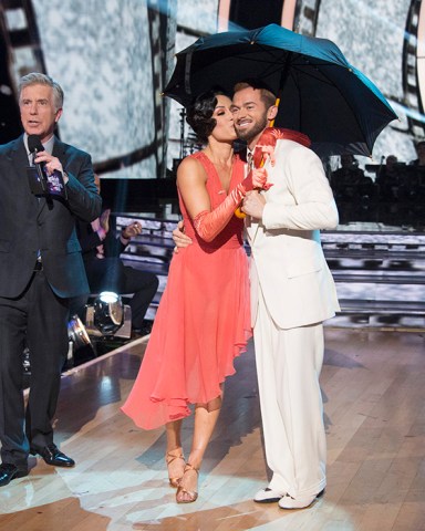 DANCING WITH THE STARS - "Episode 2506" - The nine remaining couples set their sights on the glitz and glamor of Tinseltown as they dance to celebrate "A Night at the Movies," on "Dancing with the Stars," live, MONDAY, OCTOBER 23 (8:00-10:01 p.m. EDT), on The ABC Television Network. (ABC/Eric McCandless)TOM BERGERON, NIKKI BELLA, ARTEM CHIGVINTSEV