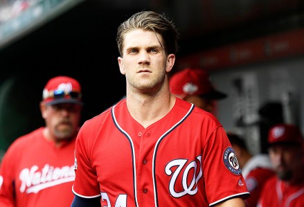 Washington Nationals' Bryce Harper looks on from the dugout before the continuation of a suspended baseball game against the New York Yankees, in Washington. This game is a continuation of a suspended game from May 15
Yankees Nationals Baseball, Washington, USA - 18 Jun 2018
