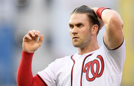 Washington Nationals' Bryce Harper runs his hand through his hair as he stands on the field after the third inning of a baseball game against the New York Yankees, in Washington. This game is a makeup of a postponed game from May 16
Yankees Nationals Baseball, Washington, USA - 18 Jun 2018
