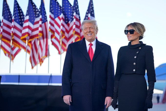 Donald Trump and Melania Trump in front of American flags