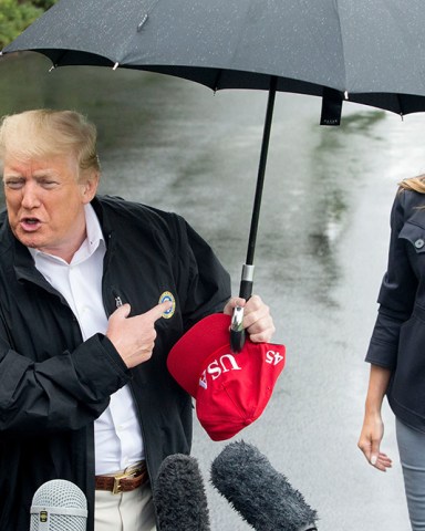 US President Donald J. Trump (L) delivers remarks to members of the news media beside First Lady Melania Trump (R), at the South Lawn of the White House before departing by Marine One, in Washington, DC, USA, 15 October 2018. Trump travels to the Florida Pandhandle and Georgia to view damage from Hurricane Michael. Before departing, Trump said he had spoken to the Saudi King Salman, regarding missing Washington Post contributor Jamal Khashoggi, and that US Secretary of State Mike Pompeo will meet with the Saudi King. US President Donald J. Trump and First Lady Melania Trump depart the White House, Washington, USA - 15 Oct 2018