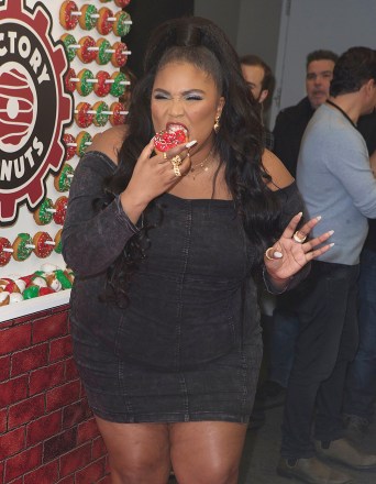 Lizzo enjoys a donut backstage during Q102's iHeartRadio Jingle Ball 2019 at the Wells Fargo Center, in Philadelphia2019 Jingle Ball - - Arrivals, Philadelphia, USA - 11 Dec 2019