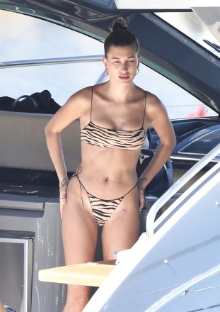 SARDINIA, Italy - Hailey Baldwin and Bella Hadid threw on their bikinis and had some lunch while relaxing on a yacht in Sardinia.  Hailey wore a leopard print bikini while Bella wore an orange bikini.  Image: Hailey Baldwin Backgrid USA 23 June 2020 MUST READ BYLINE: CIAOPIX / FREZZA LAFATA / BACKGRID USA: +1 310 798 9111 / usasales@backgrid.com UK: +44 208 344 2007 / uksales@backgrid.com * UK CUSTOMERS - PICTURES Containing children Please pixelate face before publication*