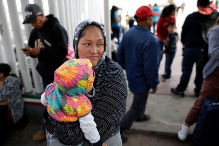 Maria Rafaela Blancante, of the Mexican state of Michoacan, holds her daughter, Jazmin, as they wait with other families to request political asylum in the United States, across the border in Tijuana, Mexico. The family has waited for two weeks in this Mexican border city, hoping for a chance to escape widespread violence in their home state
Immigration Asylum, Tijuana, Mexico - 13 Jun 2018