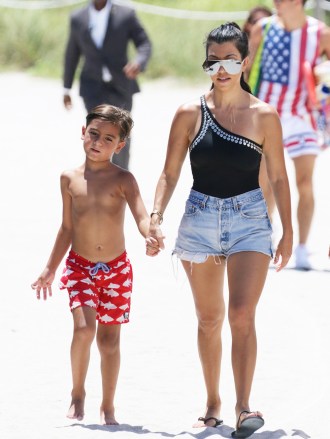 Kourtney Kardashian, 37, and her eldest son, Mason Disick at the beach of the Setai Hotel in Miami Beach, FL. Kourtney wore a one piece black swimsuit by Norma Kamali swimwear.Pictured: Mason Disick,Kourtney Kardashian,Mason DisickKourtney KardashianRef: SPL1313401 040716 NON-EXCLUSIVEPicture by: SplashNews.comSplash News and PicturesUSA: +1 310-525-5808London: +44 (0)20 8126 1009Berlin: +49 175 3764 166photodesk@splashnews.comWorld Rights, No Poland Rights