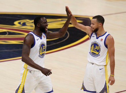 Golden State Warriors' Draymond Green, left, and Stephen Curry celebrate during the first half against the Cleveland Cavaliers in Game 3 of basketball's NBA Finals, Wednesday, June 6, 2018, in Cleveland. (AP Photo/Carlos Osorio)
