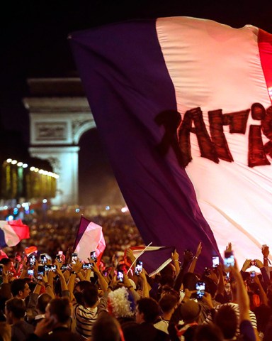The crowd invades the Champs Elysees avenue, with the Arc de Triomphe in background, to celebrate after the semifinal match between France and Belgium at the 2018 soccer World Cup, in Paris. France advanced to the World Cup final for the first time since 2006 with a 1-0 win over Belgium on TuesdayWCup Soccer, Paris, France - 10 Jul 2018