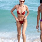 Candice Swanepoel shows off her post baby bikini body on the beach in Miami.