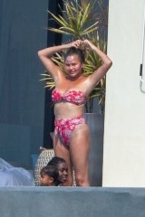 Puerto Vallarta, MEXICO - *EXCLUSIVE* Chrissy Teigen is all smiles as she kicks back in Puerto Vallarta with her family during a holiday getaway. With beaches closed in LA, the couple took off to enjoy the holiday at a seaside resort. Chrissy who recently had her breast implants removed showed off her great figure in a cheeky floral print two piece as she hung around by their pool while John caught up on rest and took a little nap.Pictured: Chrissy TeigenBACKGRID USA 6 JULY 2020 BYLINE MUST READ: HEM / BACKGRIDUSA: +1 310 798 9111 / usasales@backgrid.comUK: +44 208 344 2007 / uksales@backgrid.com*UK Clients - Pictures Containing ChildrenPlease Pixelate Face Prior To Publication*
