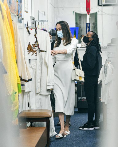 Angelina Jolie was spotted shopping at an Ethiopian Boutique store with her kids Zahara and Shiloh in Los Angeles, CA. They were seen walking through the aisles as they checked out the various Ethiopian Garb and clothing on the racks. 08 Jan 2021 Pictured: Angelina Jolie wears all white as she takes her kids Zahara and Shiloh shopping at an Ethiopian boutique in Los Angeles. Photo credit: Marksman / MEGA TheMegaAgency.com +1 888 505 6342 (Mega Agency TagID: MEGA725340_013.jpg) [Photo via Mega Agency]