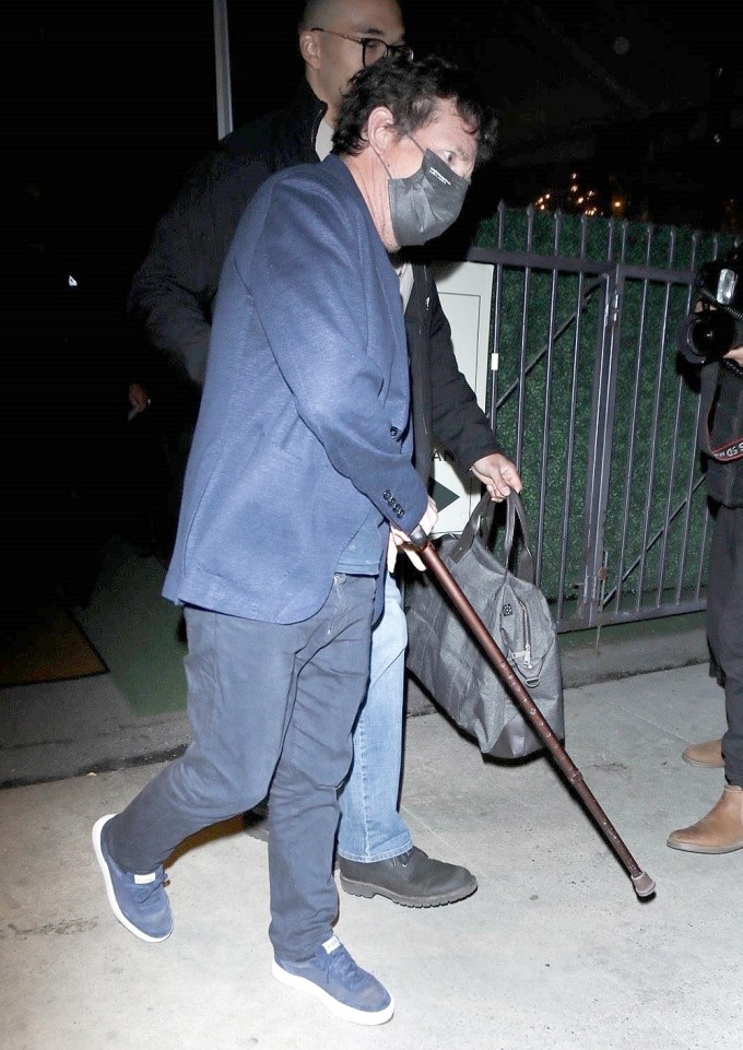 Michael J Fox uses his cane to leave dinner