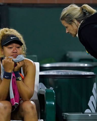 Naomi Osaka, left, of Japan, talks with an official while reacting to a comment from a spectator during her match with Veronika Kudermetova, of Russia, at the BNP Paribas Open tennis tournament, in Indian Wells, Calif Tennis, Indian Wells, United States - 12 Mar 2022