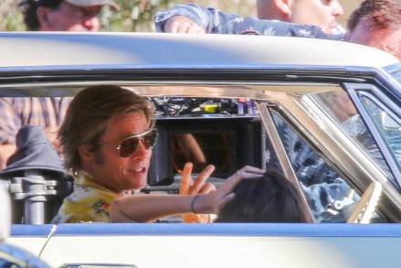 ** RIGHTS: WORLDWIDE EXCEPT IN ITALY ** Los Angeles, CA  - *EXCLUSIVE*  - Brad Pitt and Margaret Qualley are seen behind the scenes as they film "Once Upon a Time in Hollywood". Director Quinten Tarentino looks on as the two film a steamy scene in an old Cadillac for the star studded movie.Pictured: Brad Pitt, Margaret QualleyBACKGRID USA 20 OCTOBER 2018 USA: +1 310 798 9111 / usasales@backgrid.comUK: +44 208 344 2007 / uksales@backgrid.com*UK Clients - Pictures Containing ChildrenPlease Pixelate Face Prior To Publication*