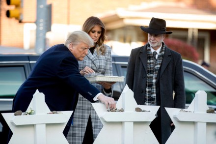 Donald Trump, Melania Trump, Jeffrey Myers. From left, President Donald Trump, accompanied by first lady Melania Trump, and Tree of Life Rabbi Jeffrey Myers, puts down a stone from the White House at a memorial for those killed at the Tree of Life Synagogue in Pittsburgh
Trump, Pittsburgh, USA - 30 Oct 2018