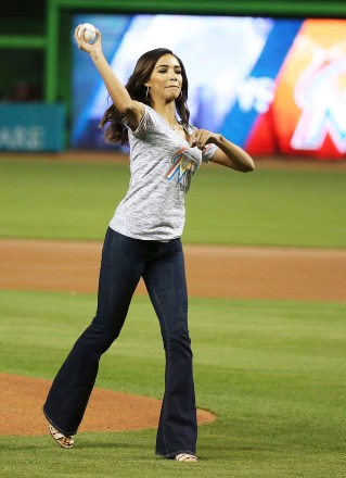 CBS4's Traffic Reporter Bianca Peters throws out a ceremonial first pitch before the start of a baseball game between the Miami Marlins and the Colorado Rockies, in Miami
Rockies Marlins Baseball, Miami, USA - 11 Aug 2017