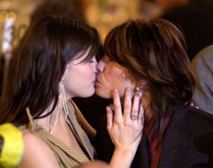 Actress Liv Tyler kisses her father, Aerosmith vocalist Steven Tyler, at the 16th Annual Rock and Roll Hall of Fame Induction Dinner Monday, March 19, 2001, in New York. (AP Photo/Kathy Willens)