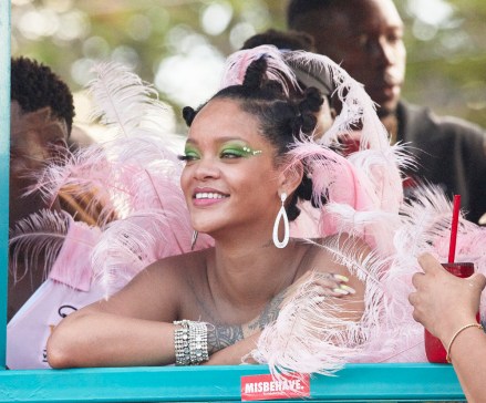 Rihanna gets visibly emotional many times when she sees her family and friends at Crop Over Festival in her native Barbados. She is seen pleading with police officer to give her float more time to stall on the road while she takes photos with friends and family. The iconic entertainer un-ironically sticks a "Misbehave" sticker in front of her on the float and then proceeds to smoke cigars.Seen coincidentally in green eye make up and nails just a few days after she followed Spotify, whose logo is green, on Instagram, sending fans into a frenzy.Pictured: RihannaRef: SPL5107670 050819 NON-EXCLUSIVEPicture by: SplashNews.comSplash News and PicturesLos Angeles: 310-821-2666New York: 212-619-2666London: 0207 644 7656Milan: +39 02 56567623photodesk@splashnews.comWorld Rights