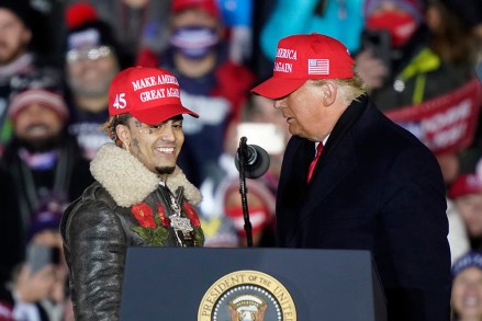 President Donald Trump brings rapper Lil Pump to the podium during a campaign event early Tuesday, Nov. 3, 2020, in Grand Rapids, Mich. (AP Photo/Carlos Osorio)