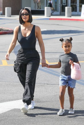 Calabasas, CA  - *EXCLUSIVE*  - Kim Kardashian and daughter North West held hands as they enjoyed a mommy/daughter shopping date with friends at the Neiman Marcus in Calabasas. Kim showed off her wasp waist in a black tank top and cargo pants, while North was adorable with her hair in two mini buns.Pictured: Kim Kardashian, North WestBACKGRID USA 31 JULY 2018 BYLINE MUST READ: BAHE / BACKGRIDUSA: +1 310 798 9111 / usasales@backgrid.comUK: +44 208 344 2007 / uksales@backgrid.com*UK Clients - Pictures Containing ChildrenPlease Pixelate Face Prior To Publication*