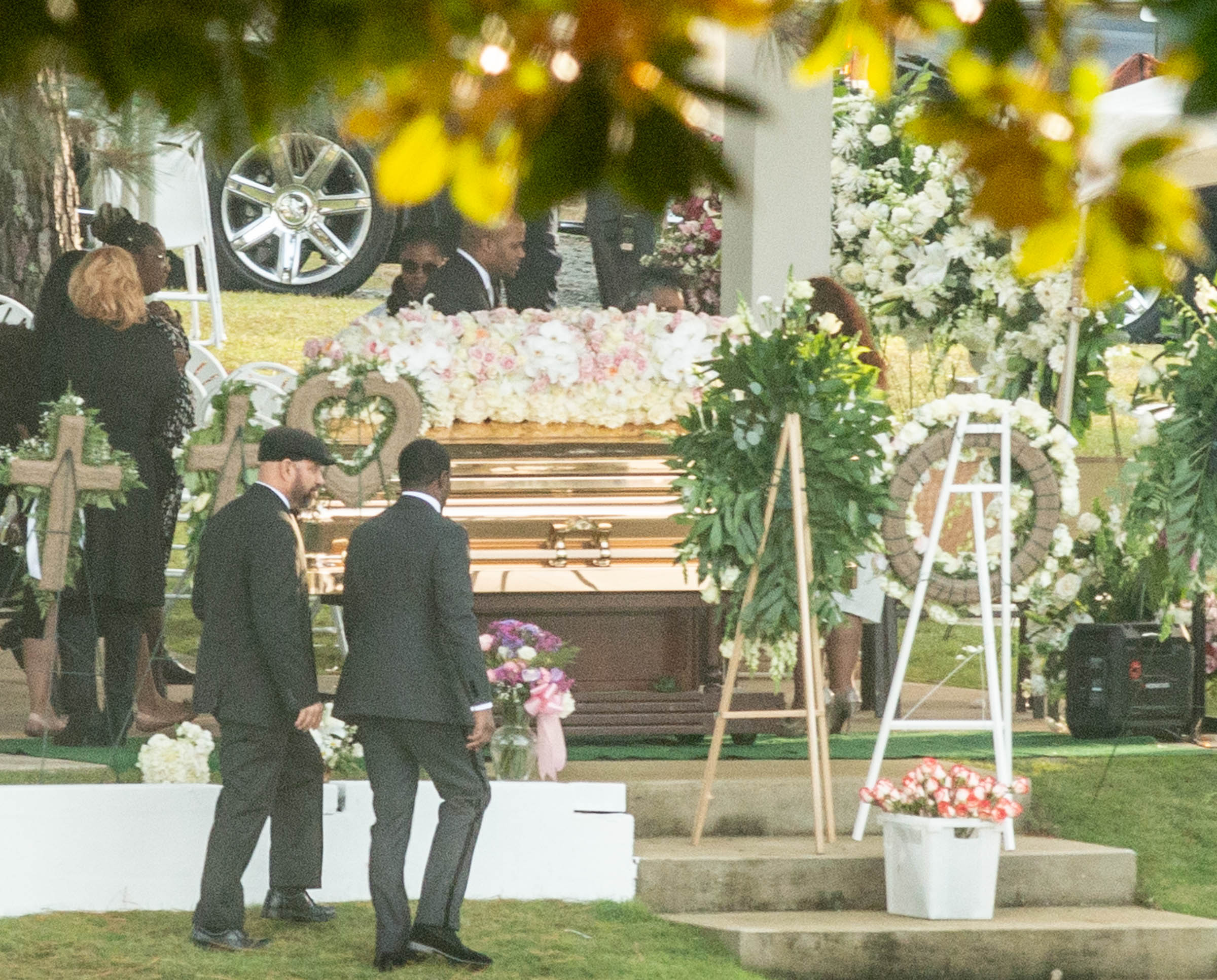 Tragic Kim Porter's golden casket spotted at graveyard as Sean 'Diddy' Combs, Usher and mourners gather.