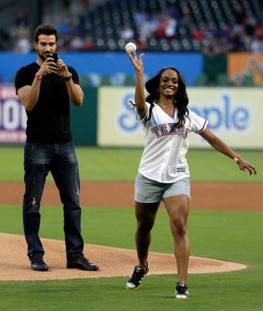 Rachel Lindsay, Bryan Abasolo Rachel Lindsay, a Dallas attorney and contestant of "The Bachelorette," throws out the ceremonial first pitch as her fiance, Bryan Abasolo, rear, records the moment before a baseball game between the Houston Astros and the Texas Rangers, in Arlington, Texas
Astros Rangers Baseball, Arlington, USA - 11 Aug 2017