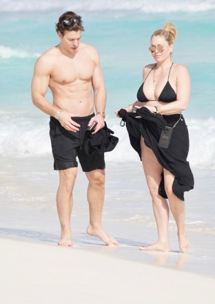 EXCLUSIVE: Shanna Moakler proves that Kourtney Kardashian and Travis Barker aren’t the only hot couple around - as she kisses her younger boyfriend on a beach in Mexico. The former pageant queen looked head over heels as she smooched on the sand with boyfriend Matthew Rondeau during a romantic vacation in Cancun. Shanna, 46, who was married to the Blink-182 drummer between 2004 and 2008 and had two children with him, looked stunning in a black bikini that she revealed after pulling down her dress. The former Playboy model and actress has had an on-again, off-again relationship with Matthew, 28, since 2000. 16 Dec 2021 Pictured: Shanna Moakler and Matthew Rondeau. Photo credit: MEGA TheMegaAgency.com +1 888 505 6342 (Mega Agency TagID: MEGA814449_011.jpg) [Photo via Mega Agency]