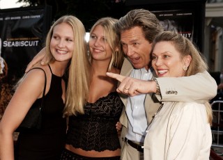 Cast members of the film "Seabiscuit," Jeff Bridges, second from right, directs his family's attention to the cameras as they arrive to the premiere of the film Tuesday, July 22, 2003, in Los Angeles. Bridges is accompanied by his wife Susan, right, and their daughters Haley, left, and Jesse. (AP Photo/Kevork Djansezian)