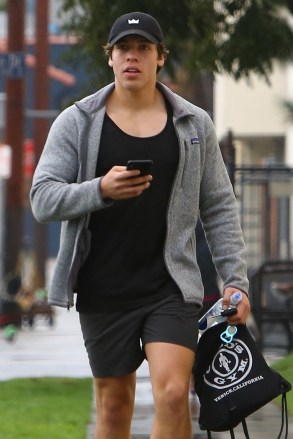 VENICE, CA - *EXCLUSIVE* - Arnold Schwarzenegger's son Joseph Baena is seen leaving Gould's gym after a morning workout in Venice.  Moving towards the car, Joseph checked his phone for messages.  Image: Joseph Baena Backgrid USA 16 January 2019 USA: +1 310 798 9111 / usasales@backgrid.com UK: +44 208 344 2007 / uksales@backgrid.com *UK Clients - Images with children please pixelate before publication*