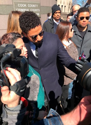 Actor Jussie Smollett poses for a selfie outside the Leighton Criminal Court Building after a hearing Tuesday, March 26, 2019, in Chicago. Smollett attorneys Tina Glandian and Patricia Brown Holmes said in a statement Tuesday that Smollett's record "has been wiped clean." Smollett was indicted on 16 felony counts related to making a false report that he was attacked by two men who shouted racial and homophobic slurs. (AP Photo/Amanda Seitz)