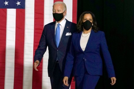 Democratic presidential candidate former Vice President Joe Biden and his running mate Sen. Kamala Harris, D-Calif., arrive to speak during a news conference at Alexis Dupont High School in Wilmington, Del., Wednesday, Aug. 12, 2020. (AP Photo/Carolyn Kaster)