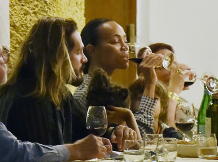 Portofino, ITALY  - *EXCLUSIVE*  - Actress Zoe Saldana and husband Marco Perego enjoy some fine Italian dining during a family dinner at the "Taverna Del Marinaio" Restaurant in Portofino.Zoe was seen thoroughly enjoying her Italian vacation as she sat at the table drinking a glass of wine and toasting the rather special occasion.Pictured: Zoe Saldana - Marco PeregoBACKGRID USA 15 SEPTEMBER 2021 BYLINE MUST READ: Cobra Team / BACKGRIDUSA: +1 310 798 9111 / usasales@backgrid.comUK: +44 208 344 2007 / uksales@backgrid.com*UK Clients - Pictures Containing ChildrenPlease Pixelate Face Prior To Publication*